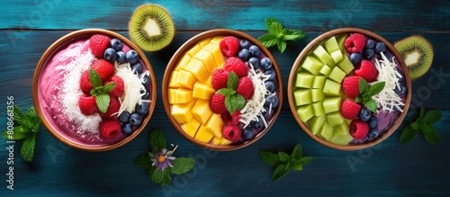 A top down view of vegan berry smoothie bowls featuring the vibrant combination of mango and coconut perfect for a healthy food concept The image leaves ample space for copy photo