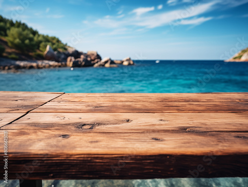 Empty wooden table top with sea and mountains on background. Summer nature backdrop with wooden table podium for product display and commercial