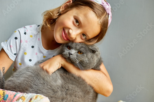Teen girl with a broken arm orthopedic cast play with cat