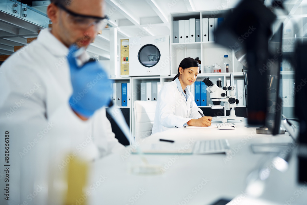 Scientist, woman and writing notes for research, test and chemical analysis for health innovation in lab on microscope. Dropper, science and medical study of drugs, liquid and exam for biotechnology Scientist, woman and writing notes for research, test and chemical analysis for health innovation in lab on microscope. Dropper, science and medical study of drugs, liquid and exam for biotechnology
