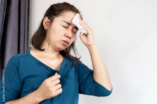 asian woman suffering from hot weather feeling tired and vertigo because of heat wave in summer