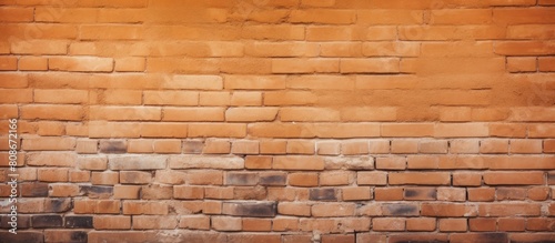 An orange brick wall with a textured surface perfect for wallpaper with ample copy space image