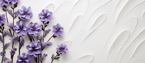 A floral pattern of purple violets and lavender flowers is depicted on a light ceramic background creating a visually pleasing copy space image