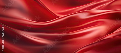 Background image of red satin or silk fabric with motion blur and radial effect Perfect for copy space