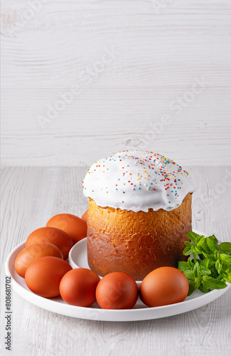 Delicious Easter cake and eggs on light background, with copy space for text