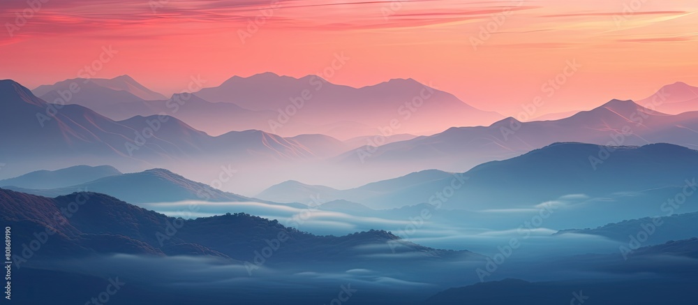 Mountains illuminated by a striking red sunset with fog enveloping the terrain. Copy space image. Place for adding text and design