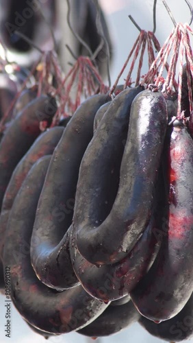 Blood sausages hanging together a grill. 4K Vertical photo