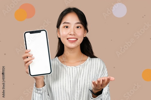 positive young korean woman showing cell phone