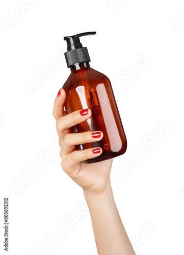 Hand holding plastic tube product on isolated background.