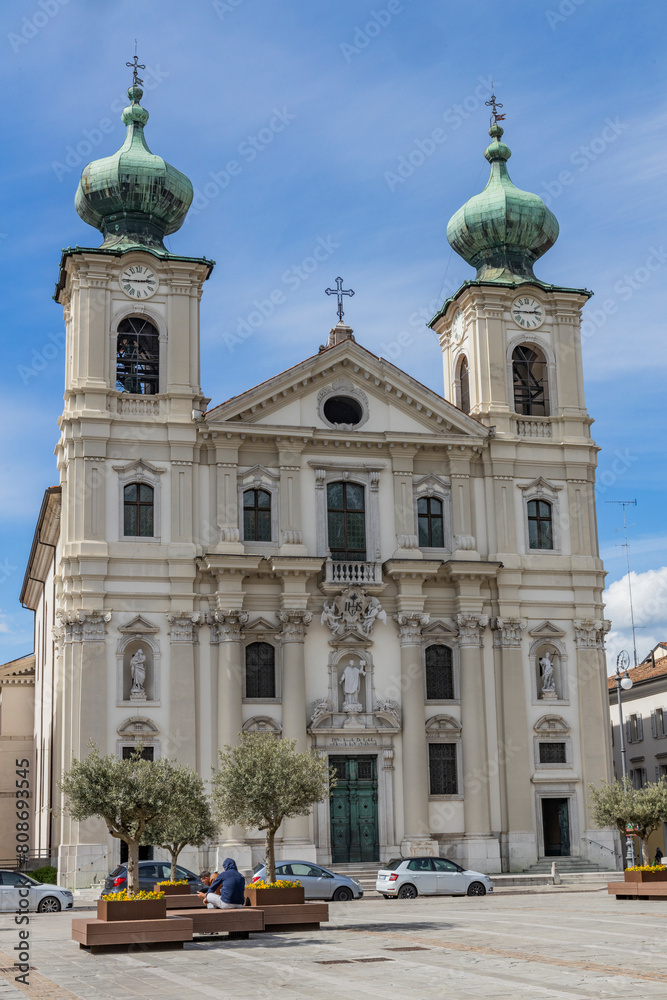 Obraz premium City of Gorizia, Piazza della Vittoria with the Church of Sant'Ignazio and the fountain. The beautiful streets and the castle behind them are a trace of history. Cultural Heritage Capital 2025.