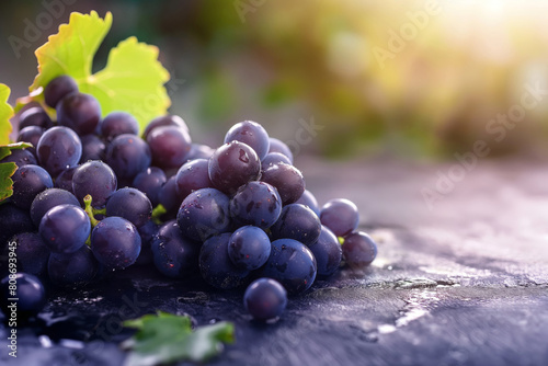 Close-up shot of dewy dark grapes with a sunlit backdrop, symbolizing health and vitality