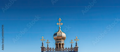 Aerial view of an orthodox temple with a crucifix on its roof set against a clear blue sky with plenty of copy space for an image photo