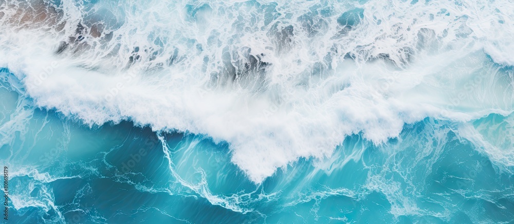 Aerial view of the ocean waves with a blue water background providing a natural backdrop Copy space is available for additional elements