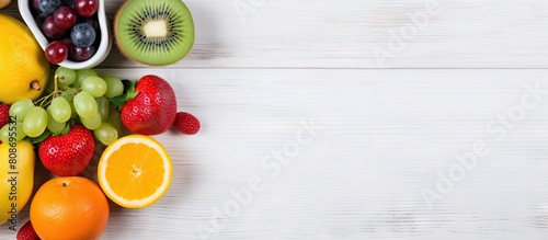 Fitness concept and diet plan displayed with dumbbells a notebook and a selection of chopped fruits on a white wooden backdrop captured from a top down perspective providing ample copy space in the i photo