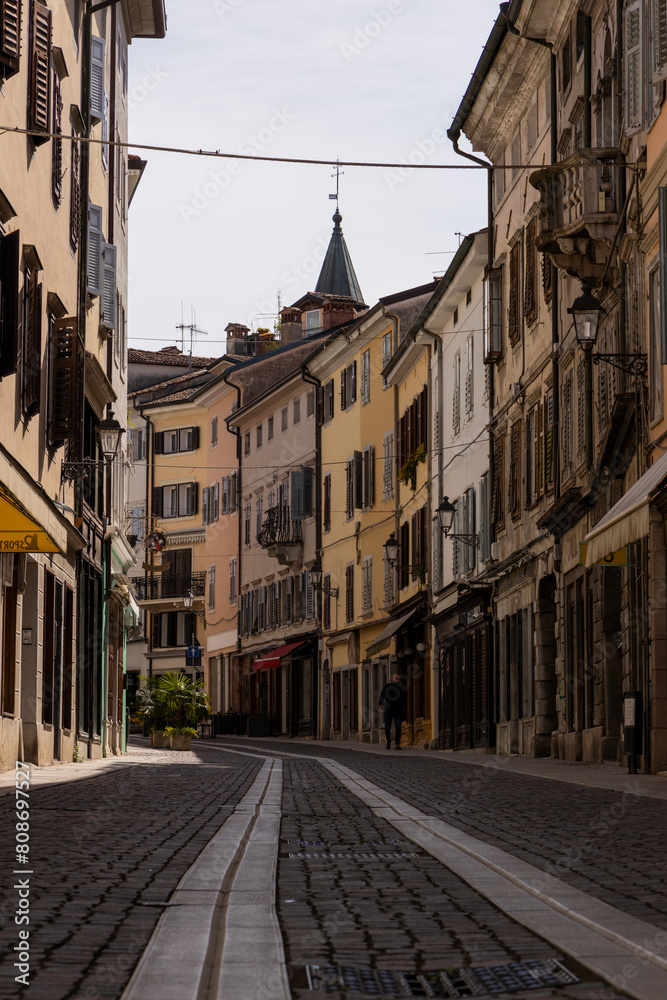 Fototapeta premium City of Gorizia, Piazza della Vittoria with the Church of Sant'Ignazio and the fountain. The beautiful streets and the castle behind them are a trace of history. Cultural Heritage Capital 2025.