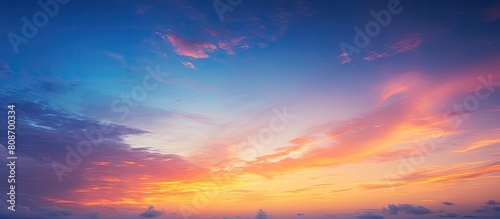 A picturesque blurred photo of the vibrant sky at sunset serving as a captivating background The image features a white square frame providing ample copy space The sky showcases a stunning gradient o