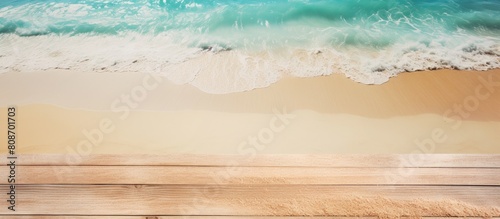 Top view copy space image of the sea against a light wooden background with sand photo