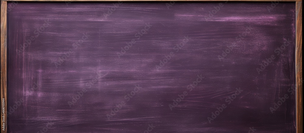 Fototapeta premium Copy space image of a purple blackboard with a blank chalkboard texture