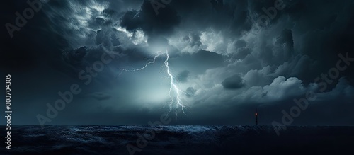 An image with a silhouette of a lightning rod standing out against a backdrop of dark storm clouds providing a perfect copy space