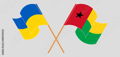 Crossed and waving flags of Ukraine and the Gambia