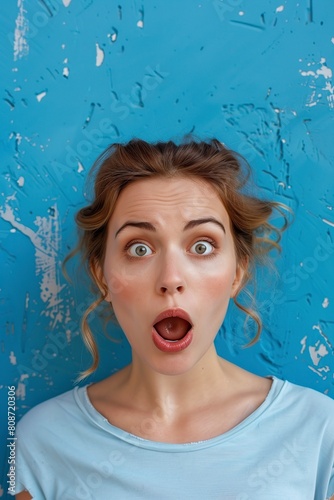 woman surprised Expression Against Blue Wall