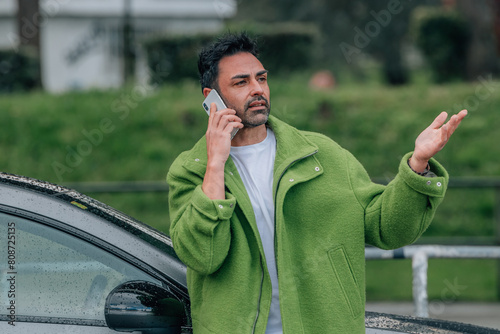 bearded man outdoors with mobile phone in the car © carballo