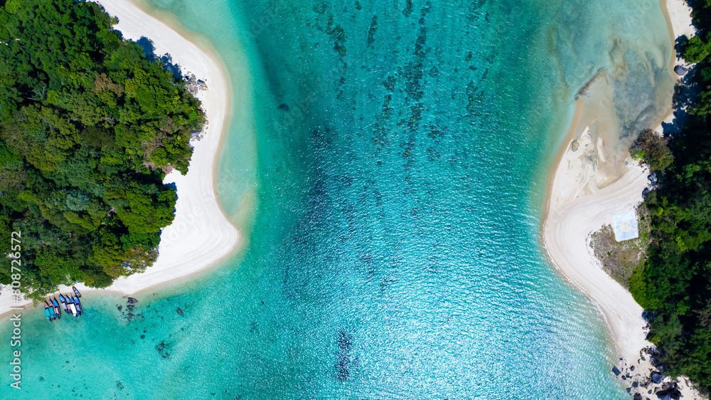 The aerial view of white sand beach tropical with seashore as the island in a coral reef ,blue and turquoise sea Amazing nature landscape with blue lagoon