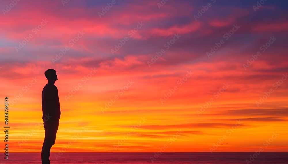 Silhouette of a Person Gazing at a Vibrant and Colorful Sunset