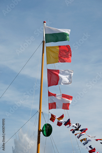 flags of the Swiss cantons of Geneva, Vaud, Valais and the province of Savoy on the mast of a steamboat in Geneva, Switzerland
