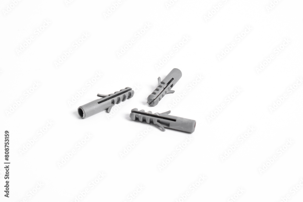 Grey plastic dowels for screws on a white isolated background Grey plastic dowels for screws on a white isolated background