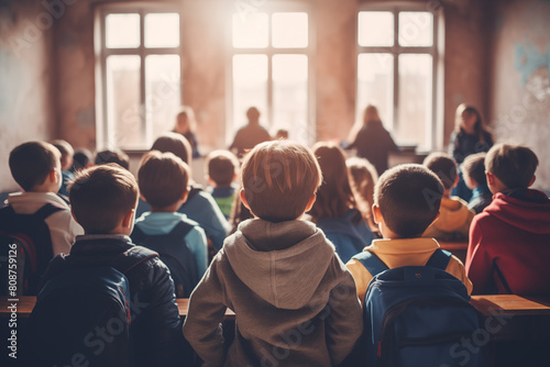 school classroom with children listening to the teacher view from the back