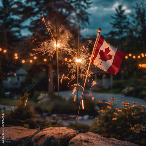 Canadian flag and sparklers placed on a rock outdoors Canada day photo