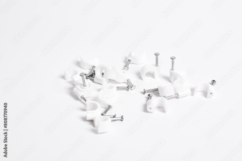 Cable nail clip, Plastic cable clips with steel nails isolated on white background Cable nail clip, Plastic cable clips with steel nails isolated on white background