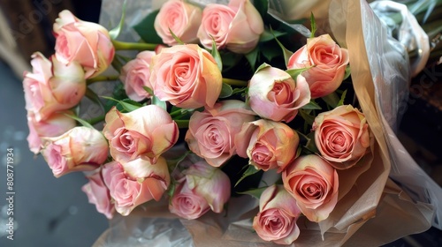 Beautiful  newly-picked pink roses wrapped in paper for a gift 