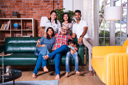 Photography Happy Indian asian family consists of grandparents, parents and kids posing for
