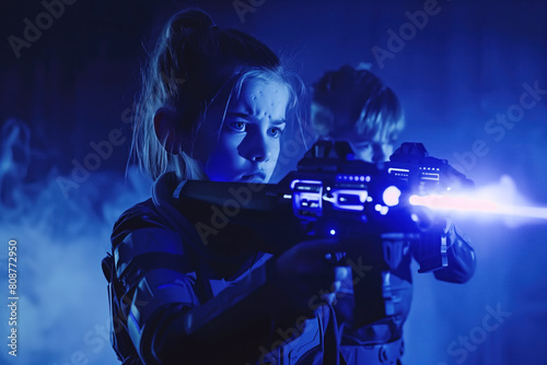 Children playing laser tag in a dimly lit arena with intense expressions.