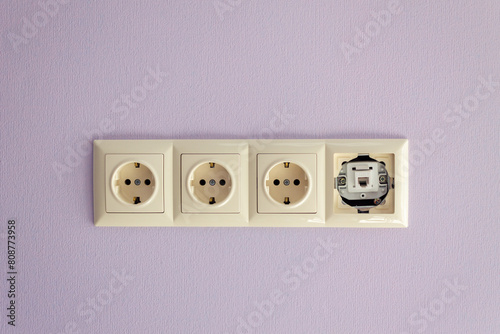Socket on a light lilac wall, European style multifunctional socket © яна винникова
