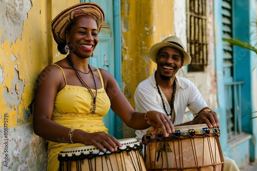 man and woman wearing a straw hat holding a drum in a Cuban rumba celebration