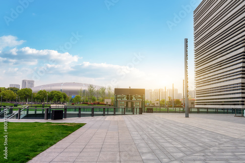 Modern Urban Plaza with Lush Greenery and Skyline