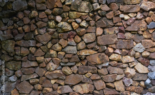 Multi-colored stones make a house wall as a background.