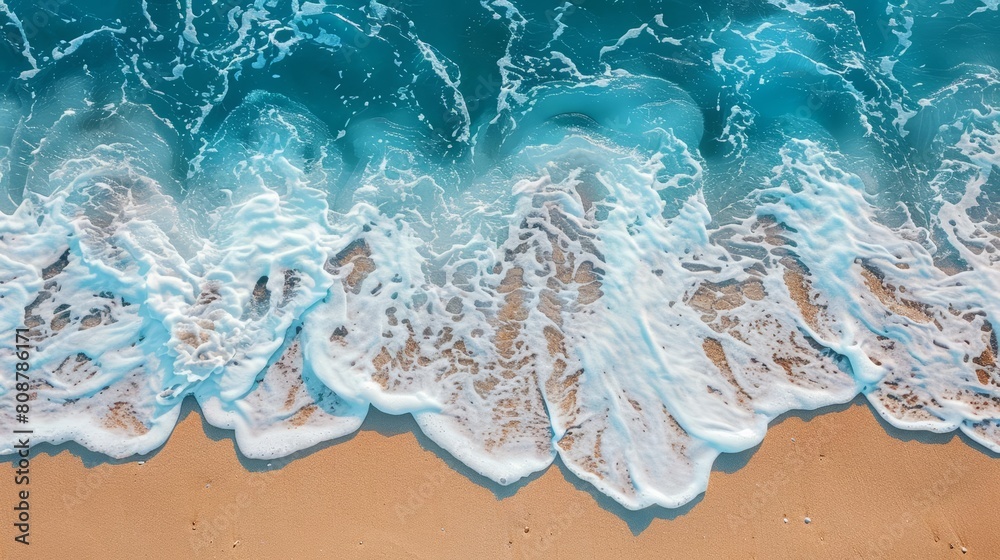 Photo of beach sand with blue water wave background, top view for summer vacation concept, in the style of unsplash photography
