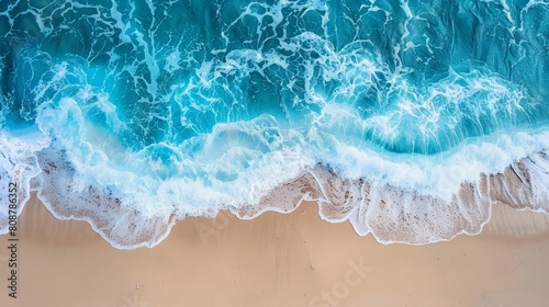 Photo of beach sand with blue water wave background, top view for summer vacation concept, in the style of unsplash photography