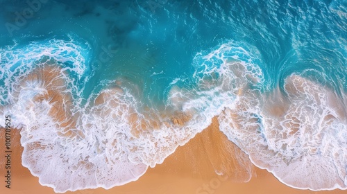Top view of a beautiful beach with soft waves and blue sea water on a sandy background