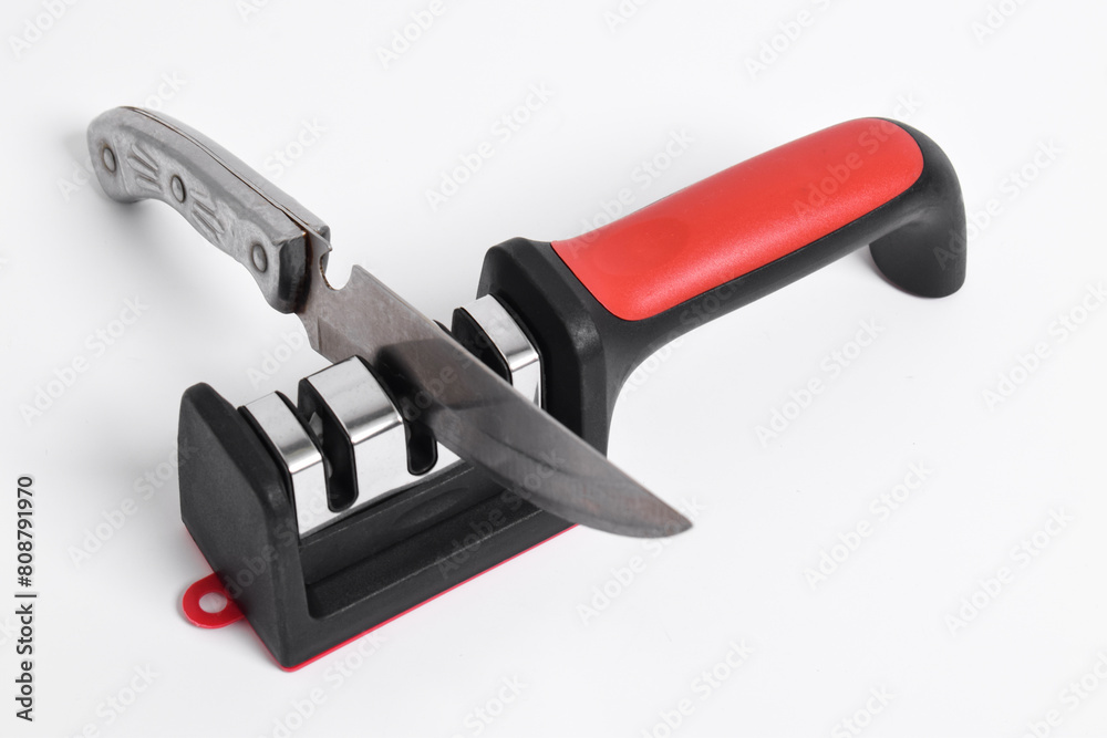 Knife and knife Sharpener isolated on white background. Manual knife sharpening, Kitchen tools Knife and knife Sharpener isolated on white background. Manual knife sharpening, Kitchen tools