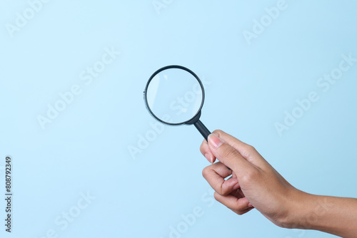 Hand Holds and Using Magnifying Glass. 