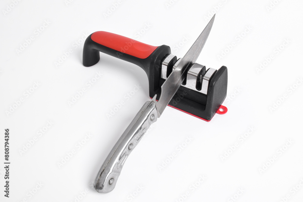 Knife and knife Sharpener isolated on white background. Manual knife sharpening, Kitchen tools