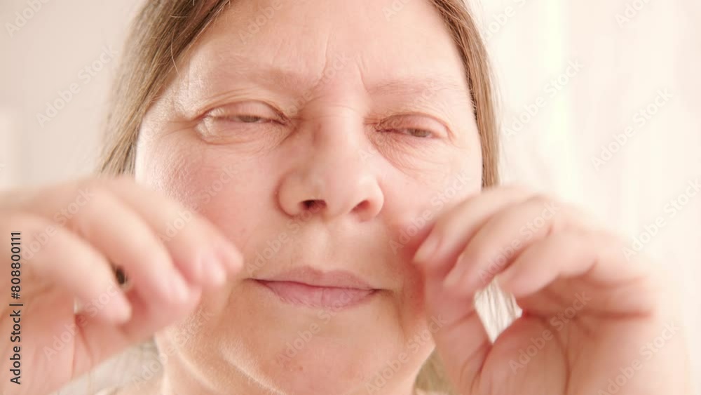 Itchy and burning eyes, close up mature woman 55 years face, eye fatigue, myopia, color perception, cosmetic anti-aging procedures Itchy and burning eyes, close up mature woman 55 years face, eye fatigue, myopia, color perception, cosmetic anti-aging procedures