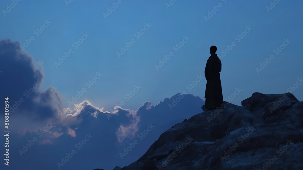 Εκτύπωση καμβά Silhouette of a Monk Standing on a Mountaintop Looking at the Sky During Dusk wi