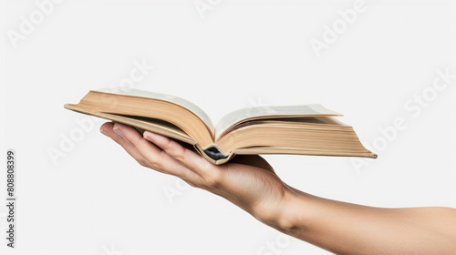 hand holding open vintage book page view from side isolated on white background created with Generative AI Technology