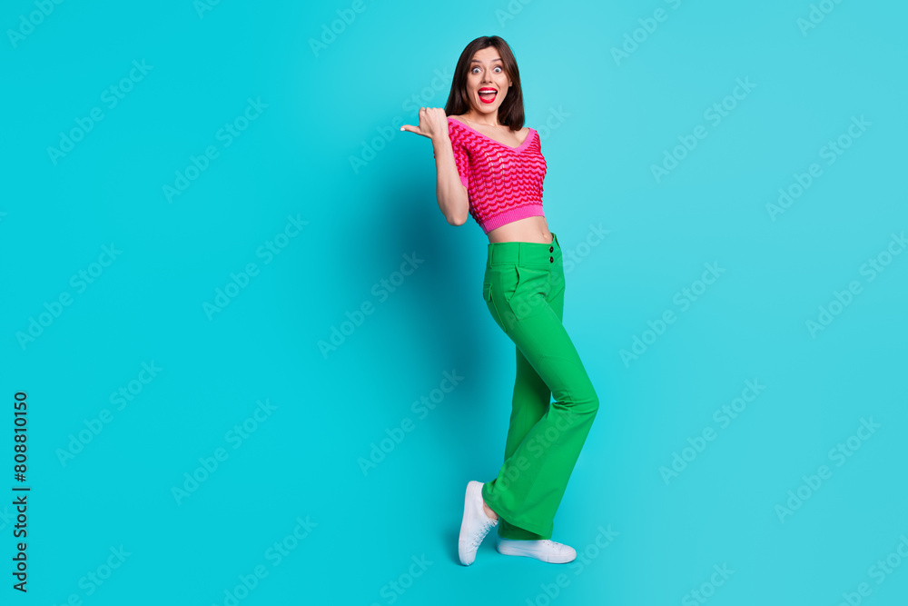 Photo of promoter lady point empty space impressed incredible brand shopping offer isolated blue color background Photo of promoter lady point empty space impressed incredible brand shopping offer isolated blue color background